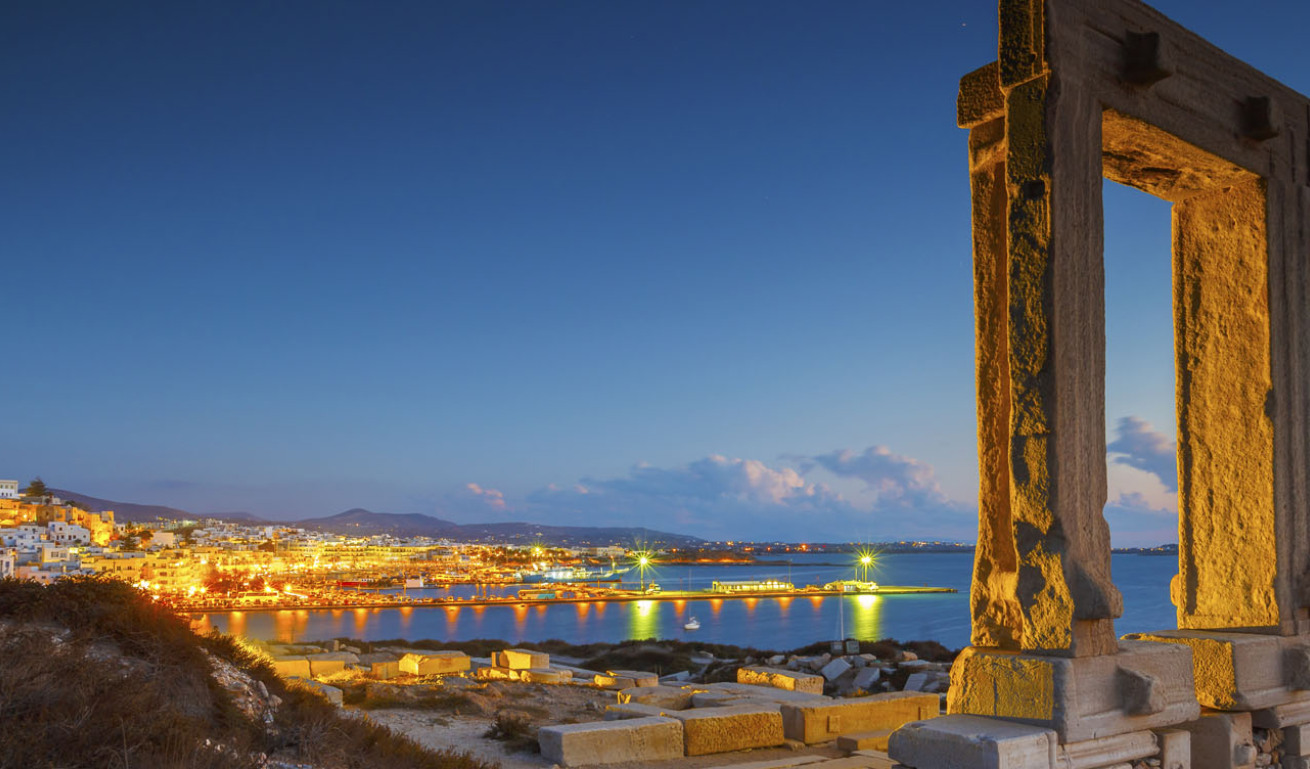 Portara in Naxos at sunset overlooking the harbor, Greece